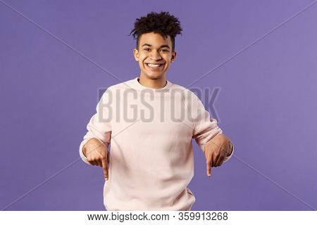 Portrait Of Cheerful, Happy Young 25s Man Recommending Product, Showing Promo Of Product, Delivery S