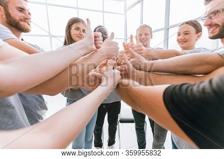 Close Up. A Group Of Young Like-minded People Showing Their Suc