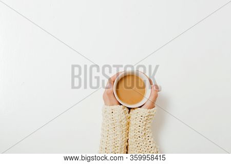 Female Hands Holding Cups Of Coffee On White Table Background