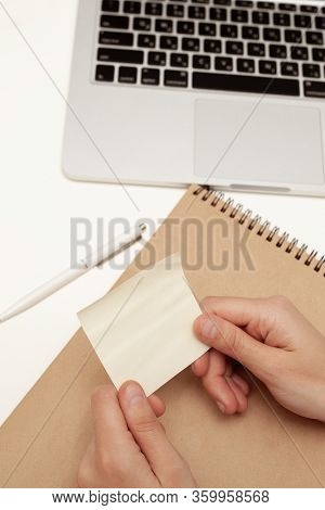 An Office Worker Holds An Empty Sticker With His Hands. Empty Space For The Text.
