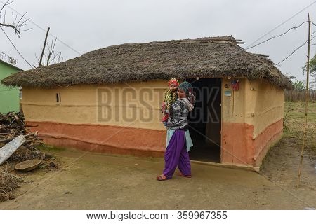 Woman In Front Of Her Traditional Rural House At Chitwan On Nepal