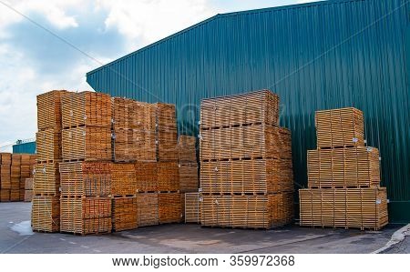 Planks In Pannels In A Store Warehouse. View From The Side. Outdoor Storage. Wood Procution