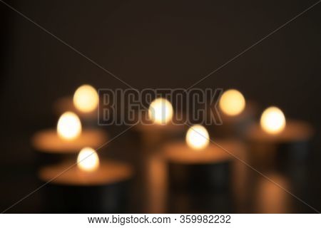 Unfocused Burning Candles In The Darkness Of A Sad Time, Sorrow And Memory