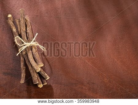 Close Up Of Ayurvedic Herb Liquorice Root,licorice Root, Mulethi Or Glycyrrhiza Glabra Root On A Woo