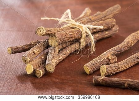 Close Up Of Ayurvedic Herb Liquorice Root,licorice Root, Mulethi Or Glycyrrhiza Glabra Root On A Woo