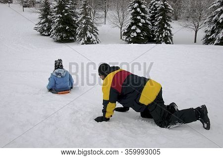 Winter Sport Toboggan - Mature Health Father And Son Playing Toboggan, Winter, Outside, Healthy Life