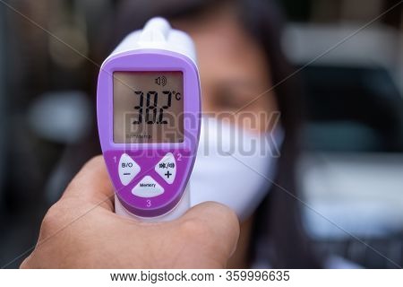 Female Doctor Checking Temperature Using Infrared Thermometer,tool For Detect Coronavirus Or Covid-1