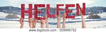 People Hands Holding Word Helfen Means Help, Snowy Winter Background