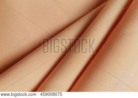 Orange Crumpled Or Wavy Fabric Texture Background. Abstract Linen Cloth Soft Waves. Gabardine Wool F