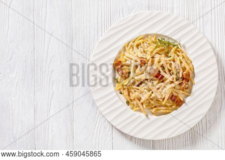 Delicious Capunti Pasta In Cream Pecorino Cheese And Pancetta Sauce On White Plate On White Wooden T