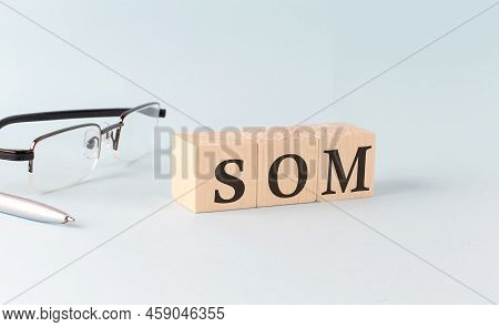 Text Som Service Oriented Management - Written On The Wooden Cubes On A Blue Background