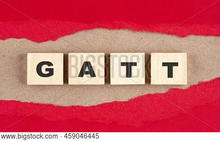 Gatt Word On Wooden Cubes On A Red Torn Paper , Financial Concept Background