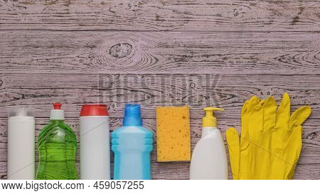 A Large Cleaning Kit On A Wooden Background. A Place For Your Text. Cleaning Kit. Flat Lay.