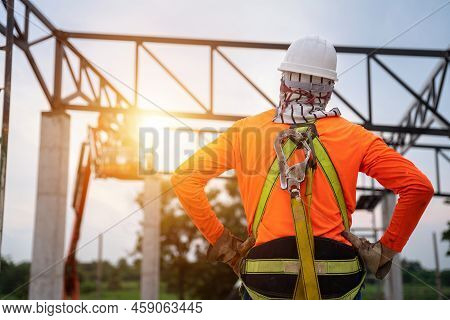 A Worker In Construction Site Working At Height Equipment. Fall Arrestor Device For Worker With Hook