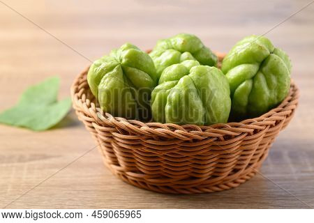 Chayote Squash Fruit In Basket On Wooden Table, Organic Vegetables