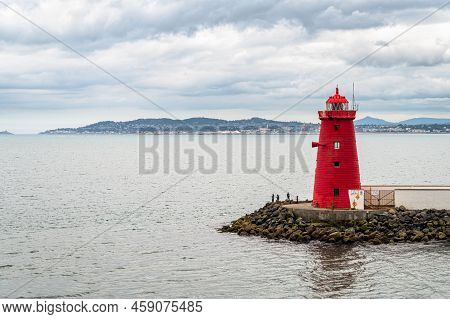 The Red Poolbeg Lighthouse At The Entrance To Dublin Port In Ireland