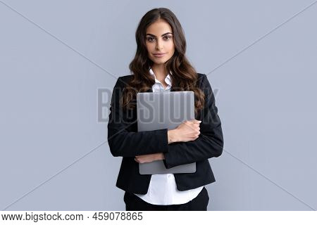 Portrait Of A Cheerful Young Casual Girl Standing Isolated Over Gray Background, Using Laptop Comput