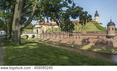 Moat Of Old Castle. Moat With Reflection In The Water And Trees. Sunny Summer Day. Palace, Tower, Co
