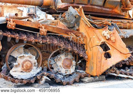 Torn Caterpillar Of A Destroyed Enemy Rusty Russian Tank Close-up. The War Between Russia And Ukrain
