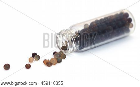 Silica Gel In A Small Glass Bottle Over White Background