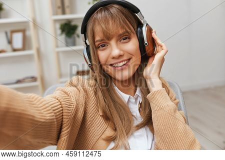 Cute Young Blonde Student Lady Freelancer In Warm Sweater In Headphones Listen Fav Songs Sitting In 