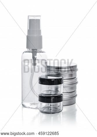 Plastic Transparent Spray Bottle, Metal Round Tin Cosmetic Can And Small Plastic Can Isolated On Whi