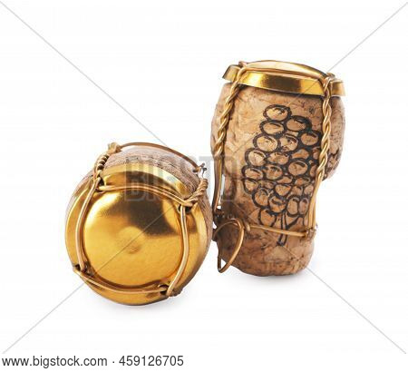 Corks Of Sparkling Wine And Muselet Caps On White Background