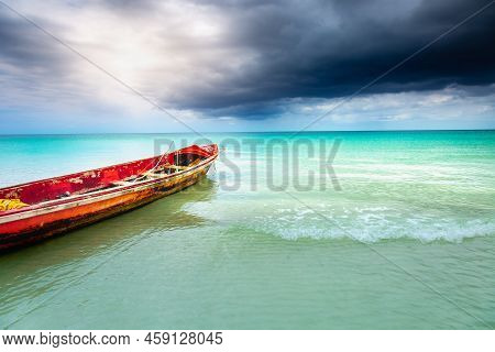 Dramatic Sky With Storm Clouds Over Caribbean Beach With Motorboat, Negril Seven Mile Beach, Jamaica
