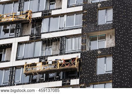 The Developer Insulates The Facade Of A House Under Construction With Mineral Insulation Around The 