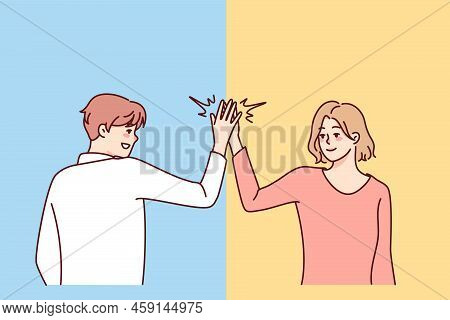 Happy Man And Woman Give High Five. Smiling People Greeting Outdoors. Body Language And Nonverbal Co