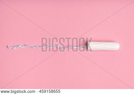 Medical Female Tampon On A Pink Background. Hygienic White Tampon For Women. Cotton Swab. Menstruati