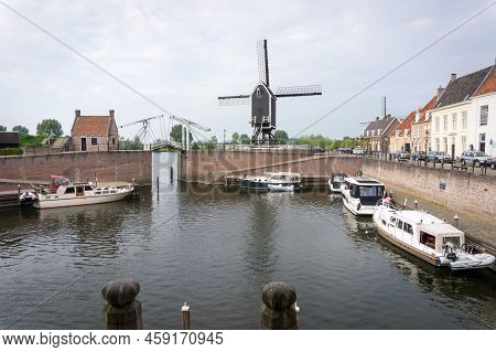 Heusden, Brabant, The Netherlands - May 7, 2022: Drawbridge And Windmill At The Harbor In The Dutch 