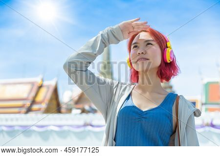 Asian Girl Teen Red Hair Colored Standing Outdoor Against High Uv Sun Light At Summer Season Sunny D