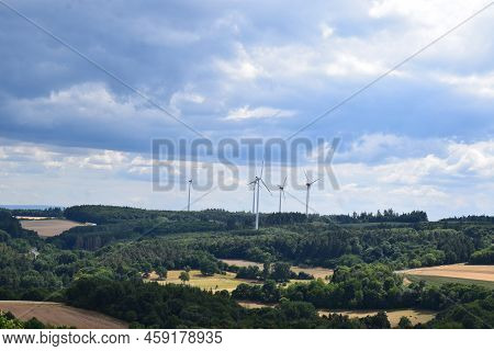 Eifel Landscape With Heavy Clouds And A Wind Power Plant