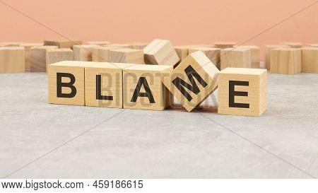 Word Blame Made With Wood Blocks. Text Is Written In Black Letters, Light Background, Business Conce