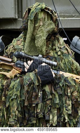 Close-up Portrait Of A Military Sniper In Camouflage Green Army Clothes With A Degtyarev Sniper Rifl