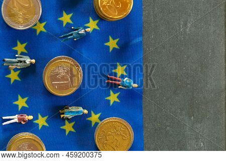Taxpayers Of Eu Countries.figurines Of People And Euro Coins On European Union Flag Background.tax A