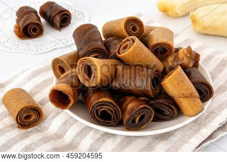 Brown Banana Pastille Rolls On Table. Homemade Mashed Fruit Pastila. Healthy Raw Snack.