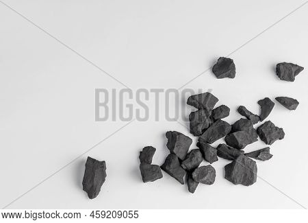 Shungite Stones On A White Background With A Copy Space.