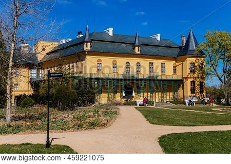 Slatinany, Czech Republic, 17 April 2022: Classical Chateau Or Romantic Yellow Castle Surrounded By 