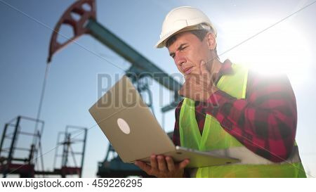 Oil Industry. Engineer Next To An Oil Rig. Oil Production Business Finance Concept. Gas Production. 