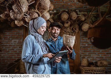 Male Entrepreneur Holding A Sample Crafts With A Hijabi Woman