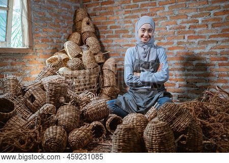 Craftswoman In Veil Sitting Among Woven Water Hyacinth Crafts