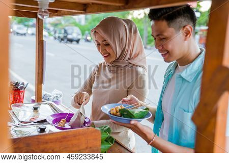 Couple Picking Some Snack And Food At Traditional Street Food Stall