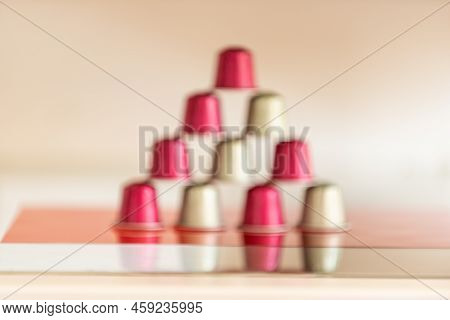Difocused Pyramid Of Italian Coffee Pods In Red Floor