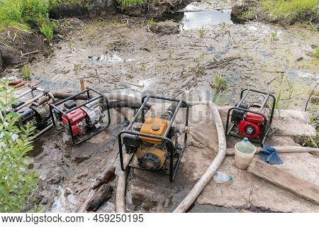 Water Pumps Pump Water From The Pond. Drainage Of Swamps Reduces The Feeding Of Small And Large Rive