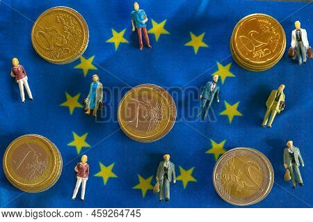 Taxpayers Of Eu Countries.figurines Of People And Euro Coins On European Union Flag.tax And Price In