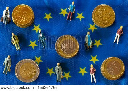Taxpayers Of Eu Countries.figurines Of People And Euro Coins On European Union Flag Background.tax A