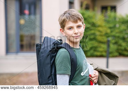 Happy Preteen Kid Boy With Backpack Or Satchel. Schoolkid In On The Way To Elementary Or Middle Scho