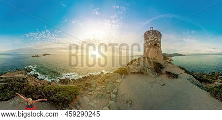 Tourist Woman Hiker Walking On Top In Punta Parata By The Sanguinaires Islands. Sunset Aerial View O